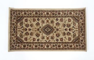 A beige ground rug. Approx. 24" x 43 1/2" Please Note - we do not make reference to the condition of