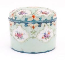 A Continental pot and cover decorated with hand painted floral vignettes. Approx. 4" high Please