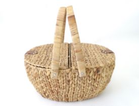A picnic basket / hamper with loop handle and hinged lids. Approx 20" long Please Note - we do not