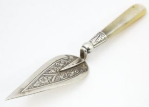 An early 20thC silver bookmark / paper clip formed as a trowel with engraved decoration and mother