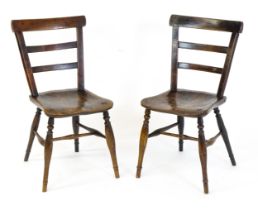 A pair of mid 19thC Windsor chairs of mixed wood construction, the chairs having bar backs and