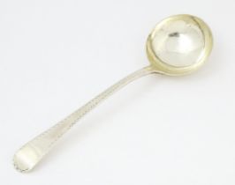 A Geo III silver sauce ladle with bright cut decoration hallmarked London c. 1778, maker Stephen
