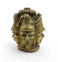 A 20thC cast brass cane top with multi face detail depicting four military figures. Approx. 1 3/4"