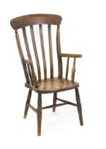 A late 19thC lathe back Windsor chair with swept arms above a shaped elm seat and raised on turned