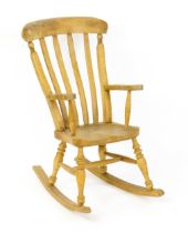 A mid 20thC child's lathe back Windsor rocking chair, with swept arms, a shaped seat and raised on