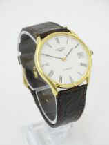 A gentlemans Longines 18ct gold cased automatic wristwatch the white dial with Roman numerals and