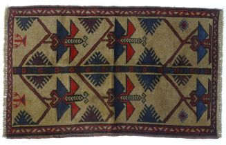 Carpet / Rug : A beige ground rug decorated with repeating geometric motifs and stylised butterflies