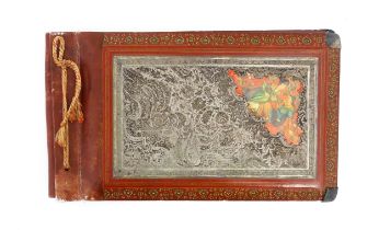 A Persian photograph album with lacquered boards decorated with a hand painted panel depicting a