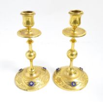 A pair of 20thC cast brass candlesticks with knopped stem and engraved decoration, the bases each