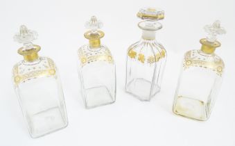 Three 19thC spirit flasks with gilt detail, and a spirit flask with fruiting vine decoration (3+