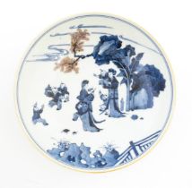 A Chinese blue and white dish / bowl decorated with figures in a landscape. Character marks under.