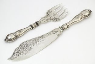 A pair of Victorian silver fish servers hallmarked Birmingham 1865, maker Thomas Prime & Son.