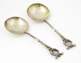 A pair of Victorian silver serving spoons with twist handles and lyre finials, hallmarked London