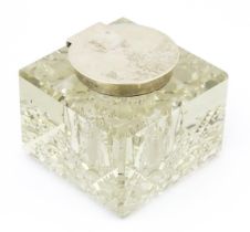 A glass inkwell of squared form with silver lid hallmarked Chester 1914, maker E. J. Clewley & Co.