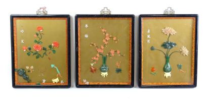 Three Chinese panels with carved hardstone decoration depicting flowers / blossom in vases. With