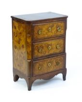 An 18thC kingwood cabinet with floral marquetry decoration inlaid to the sides and drawer fronts and