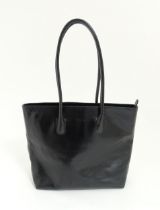 A Furla black leather handbag. Width approx. 15" Please Note - we do not make reference to the