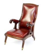 A Regency period mahogany armchair with a moulded and floral carved frame, having a shaped