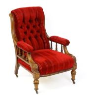 A late 19thC mahogany armchair, with deep buttoned upholstery and manchettes raised on turned