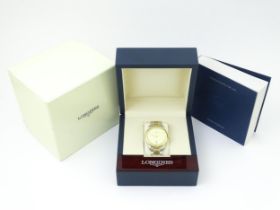 A gentlemans Longines 18ct gold and steel cased automatic wristwatch with diamond accent dial,