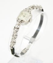 A ladies 14k white gold cased Bulova cocktail wristwatch set with diamonds. Watch case approx. 1/