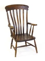 A late 19thC / early 20thC lathe back Windsor chair, with a bowed top rail, slatted back slats, a