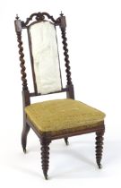 A 19thC rosewood chair with a pierced cresting rail above barley twist supports and raised on turned