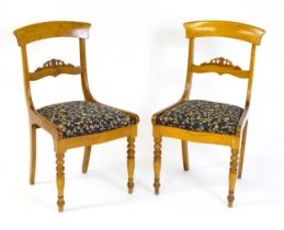 A pair of 19thC side chairs with bowed top rails, carved mid rails, drop in seats and raised on