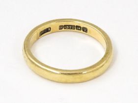 A 9ct gold ring of band form. Ring size approx. L Please Note - we do not make reference to the
