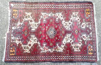 Carpet / Rug : A rug with red and cream ground decorated with geometric motifs and stylised birds