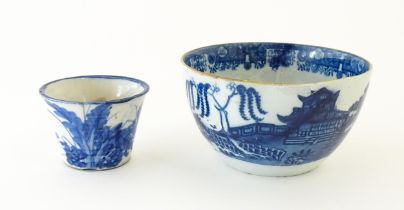 A blue and white bowl decorated with Chinese landscape with pagoda style buildings. Together with