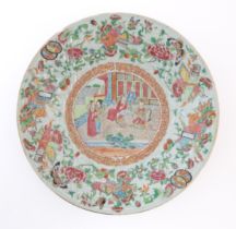 A Chinese / Cantonese famille rose plate decorated with central figural scene bordered by various