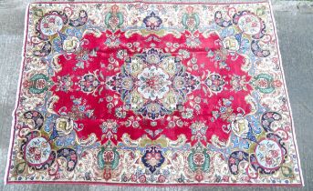 Carpet / Rug : A Persian Tabriz carpet, the red and cream grounds decorated with vignettes depicting