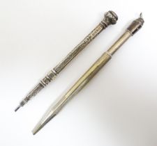 Two silver propelling pencils one with engraved acanthus scroll decoration and seal top marked .