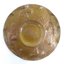 An Arts & Crafts hammered copper tray of circular form with mushroom / fungi detail in the Newlyn