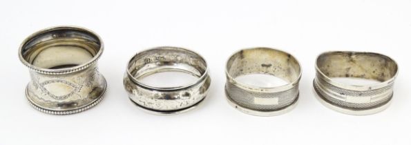 Four various 20thC silver napkin rings to include examples with engine turned decoration etc. (4)