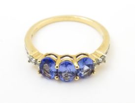 A 9ct gold ring set with purple and white stones. Ring size approx. R Please Note - we do not make