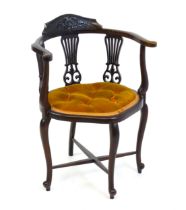 An early 20thC mahogany bow back chair with a carved cresting rail above three pierced, fanned