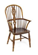 A 19thC double bow back Windsor chair with a pierced back splat, spindled backrest and a shaped seat