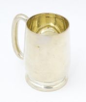 A silver christening mug with loop handle, hallmarked Birmingham 1937, maker Joseph Gloster Ltd.