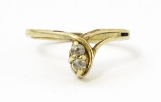 A 9ct gold ring set with white stones. Ring size approx. H Please Note - we do not make reference to