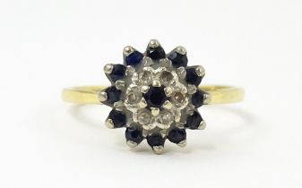 An 18ct gold ring set with diamonds and blue stones. Ring size approx. R Please Note - we do not