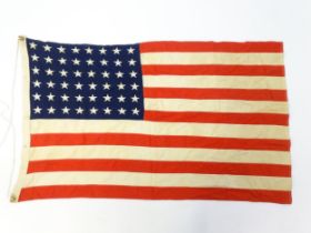 Militaria : a mid 20thC 'stars and stripes' flag of the United States of America, with 48 stars.