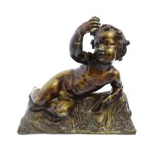 An early 20thC cast Bacchus figure modelled as a recumbent cherub with a crown of fruiting vine