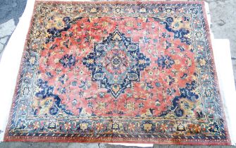 Carpet / Rug : A salmon and blue ground carpet decorated with central vignette with floral,