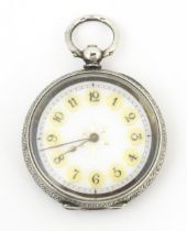 A Swiss .935 silver cased fob watch, with white enamel dial. Approx. 1 1/2" wide Please Note - we do