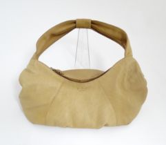 An Osprey tan leather slouch shoulder bag with floral lining. Width approx. 17 1/2" Please Note - we