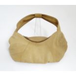 An Osprey tan leather slouch shoulder bag with floral lining. Width approx. 17 1/2" Please Note - we