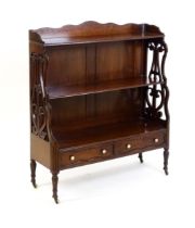 A late 19thC mahogany waterfall bookcase in the Gillows style, with a shaped and reeded upstand