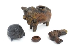 Four assorted items comprising a terracotta model of a stylised bull with flower detail, a carved